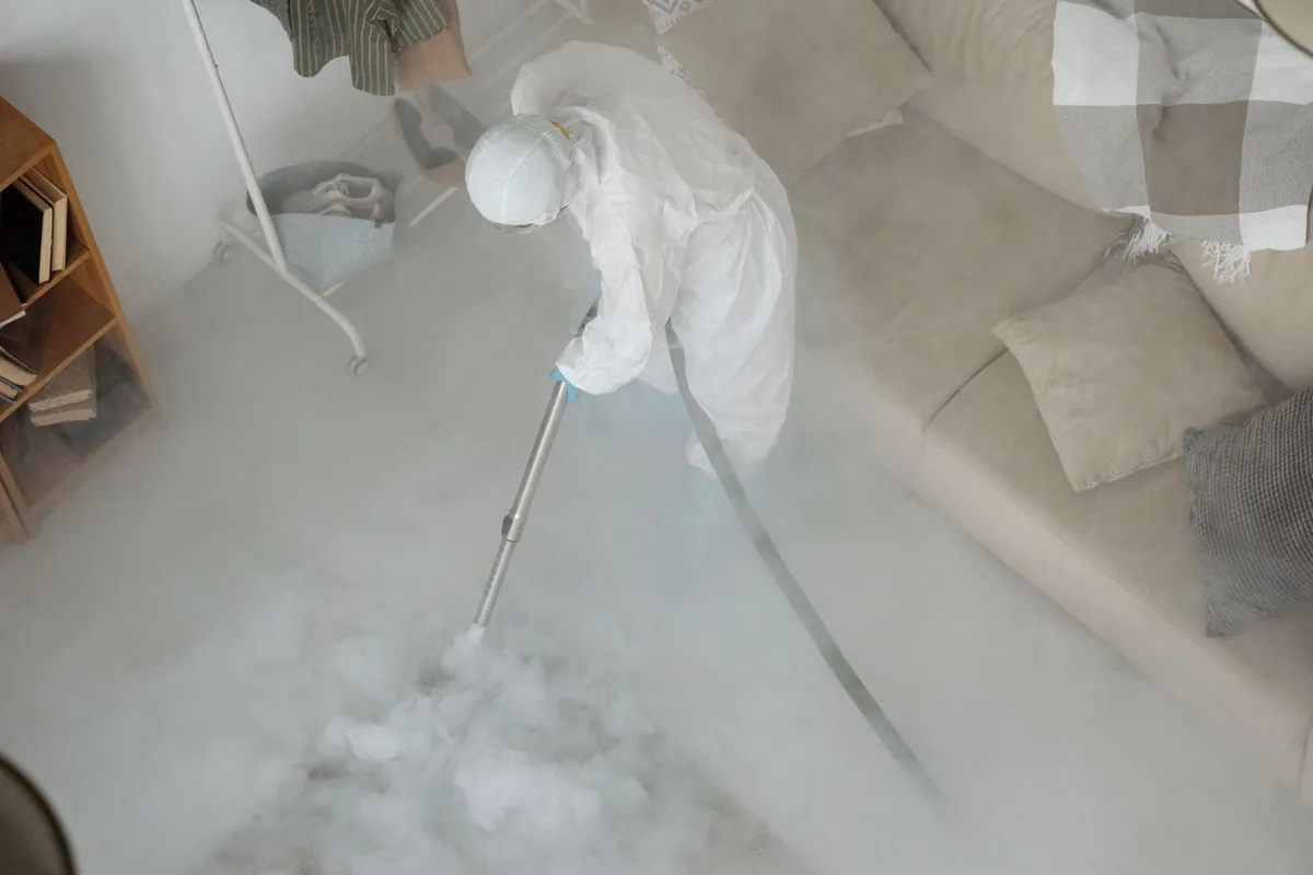 Biohazard cleanup technician in protective equipment, Afton, NY
